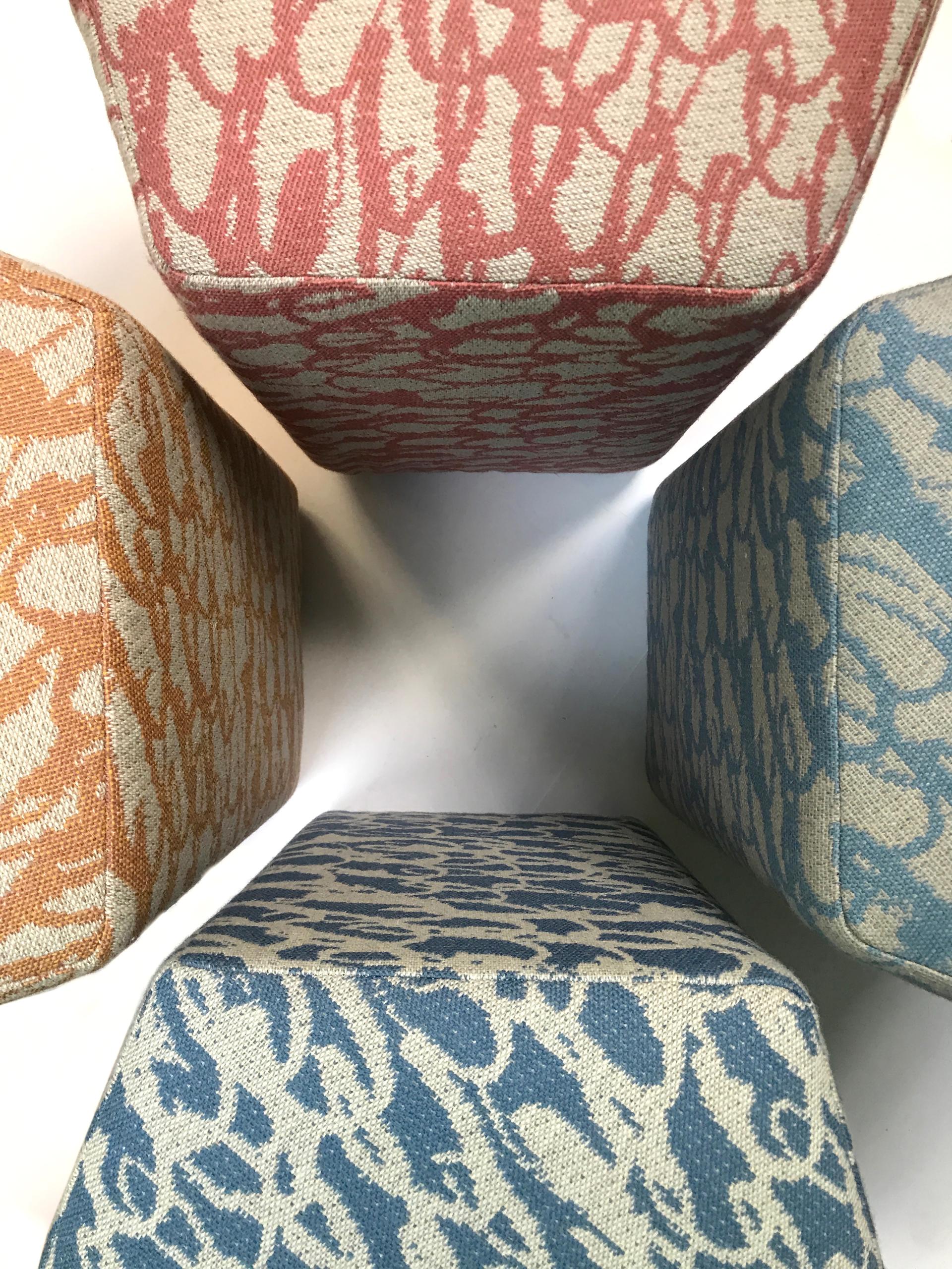 Decorative wool-covered ottomans in various colors showcase the versatility of British wool design at Yorkshire Sculpture Park.