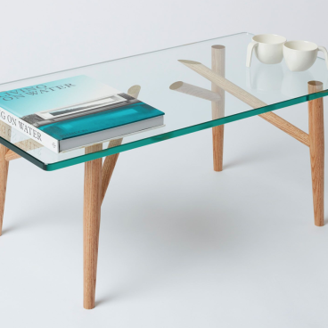 Sustainable glass and wood 'Useful Table' designed by students at East London's Building Crafts College, showcasing craftsmanship.
