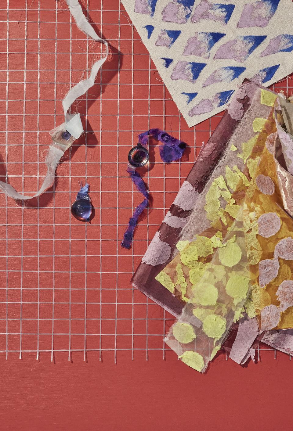 Textiles and colorful materials arranged creatively on a grid, showcasing contemporary design trends for Heimtextil 21/22.