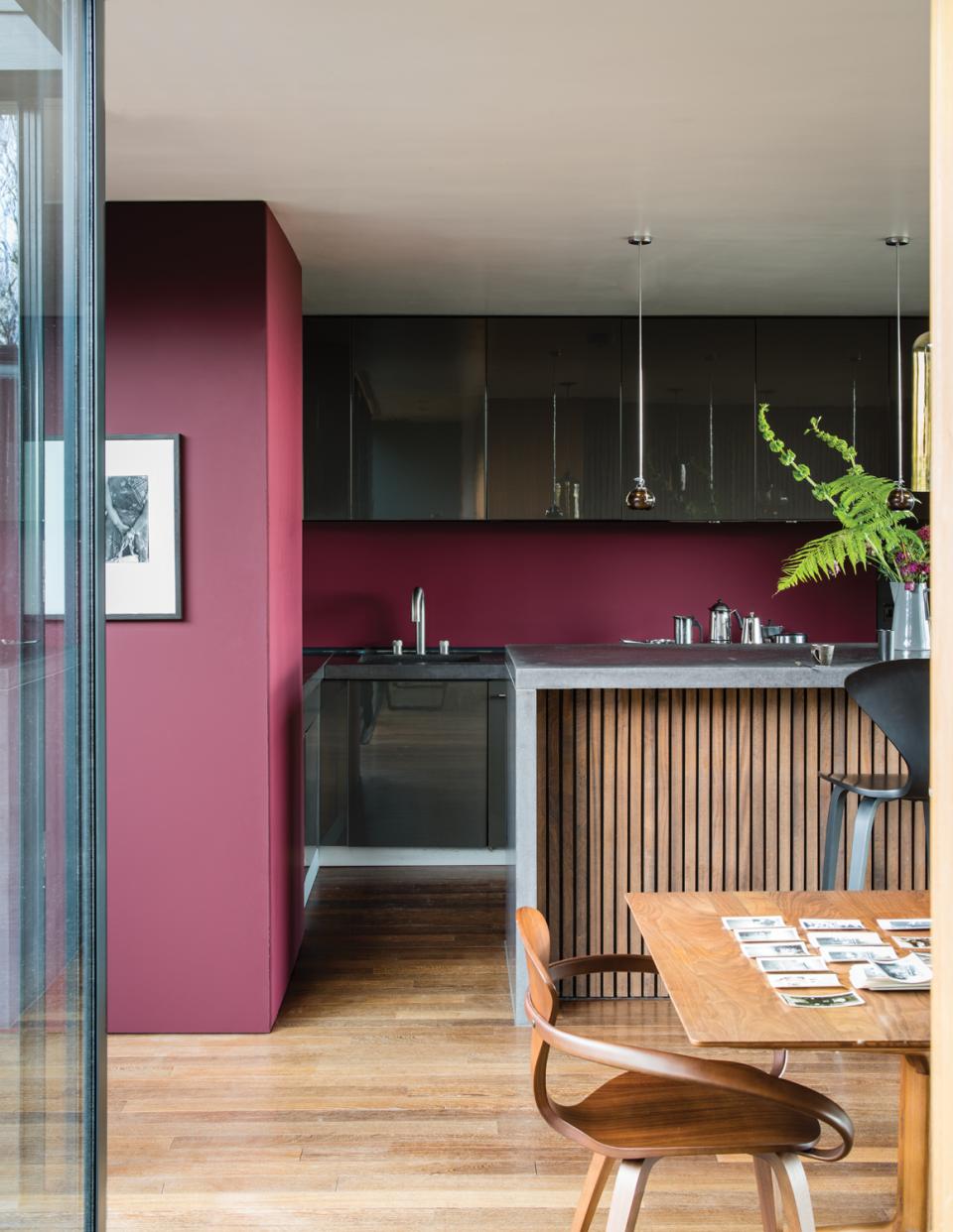 Modern kitchen featuring Farrow & Ball's Sulking Room Pink paint, wooden furniture, and sleek design elements.
