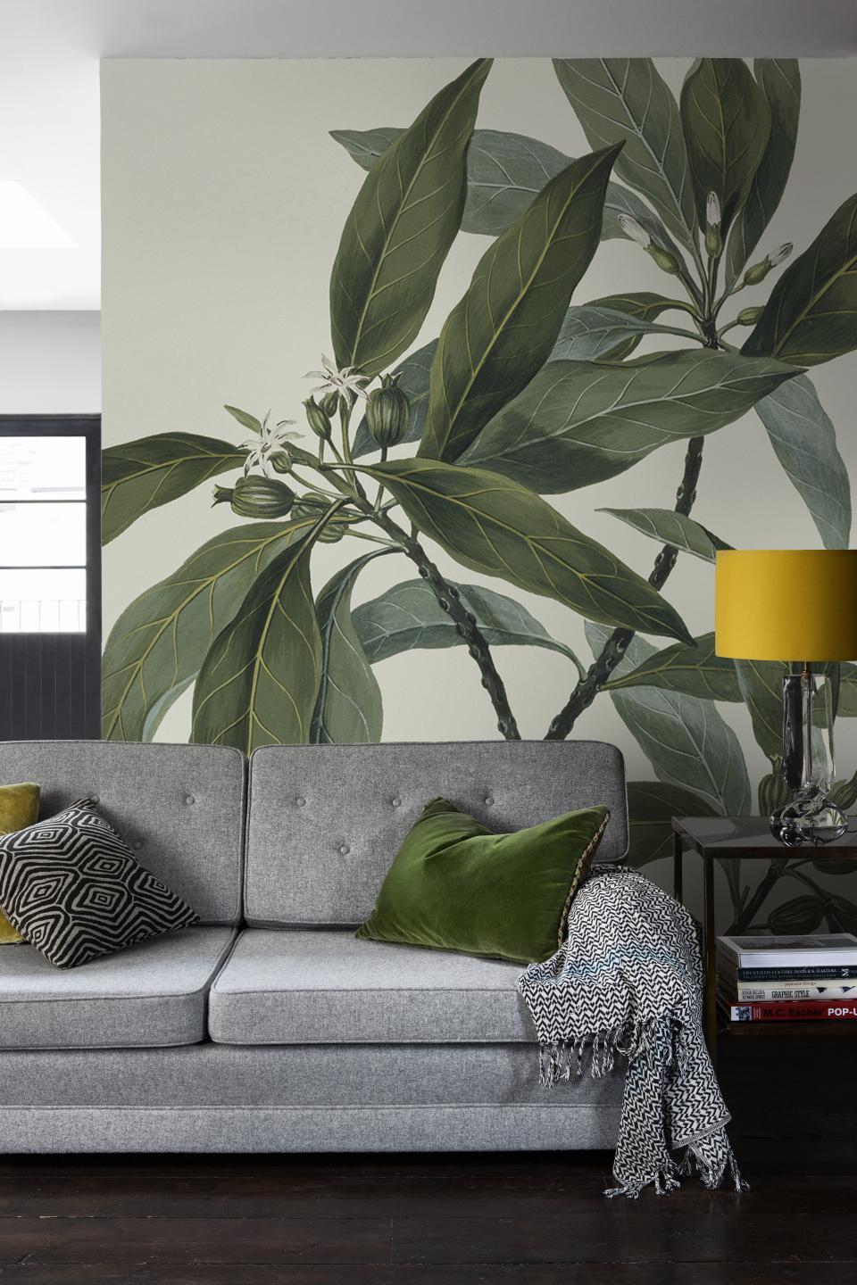 Elegant wall mural featuring lush green leaves and delicate flowers, complemented by stylish modern decor elements.