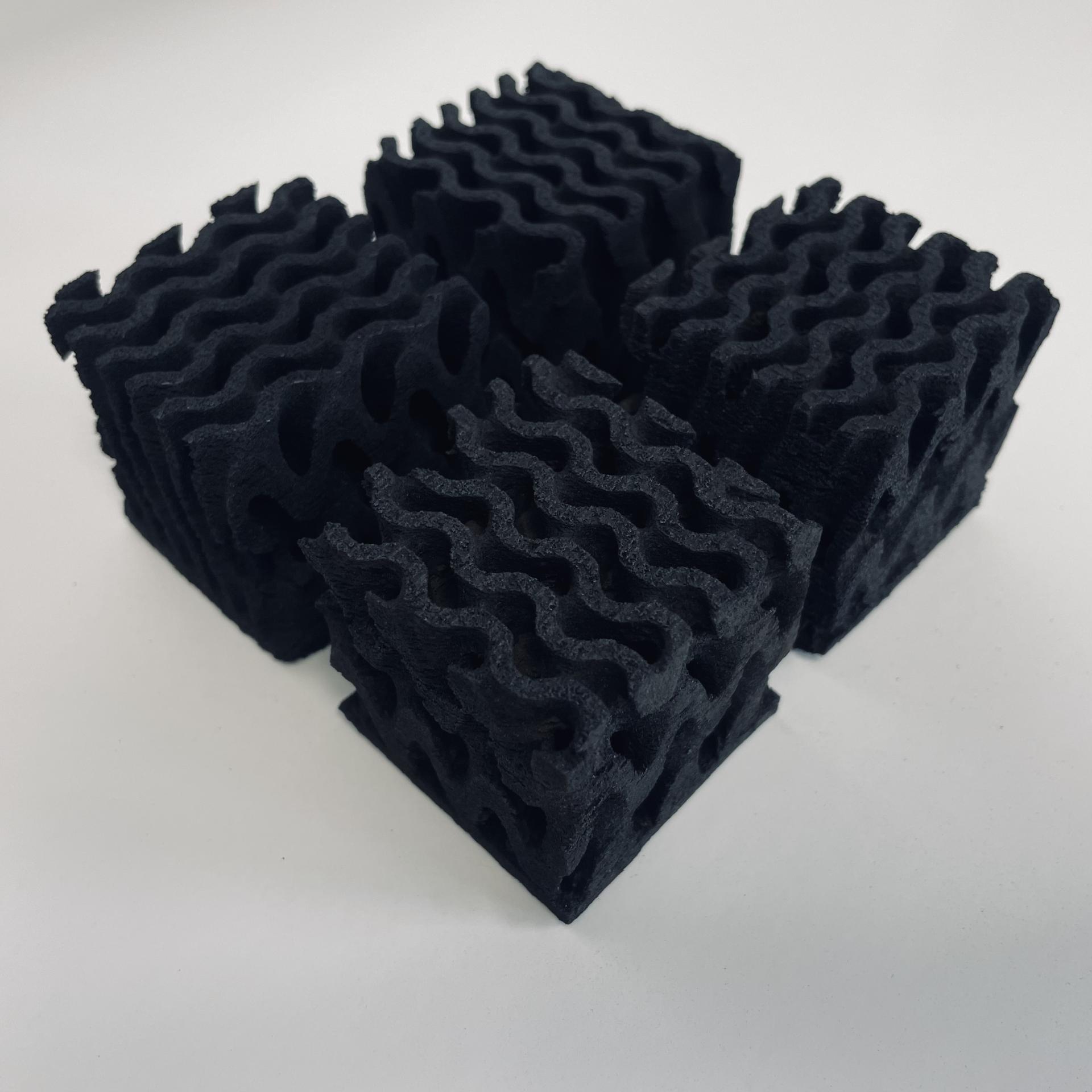 Black 3D printed foam blocks with a wavy design, showcasing innovative materials in construction technology for 2024.