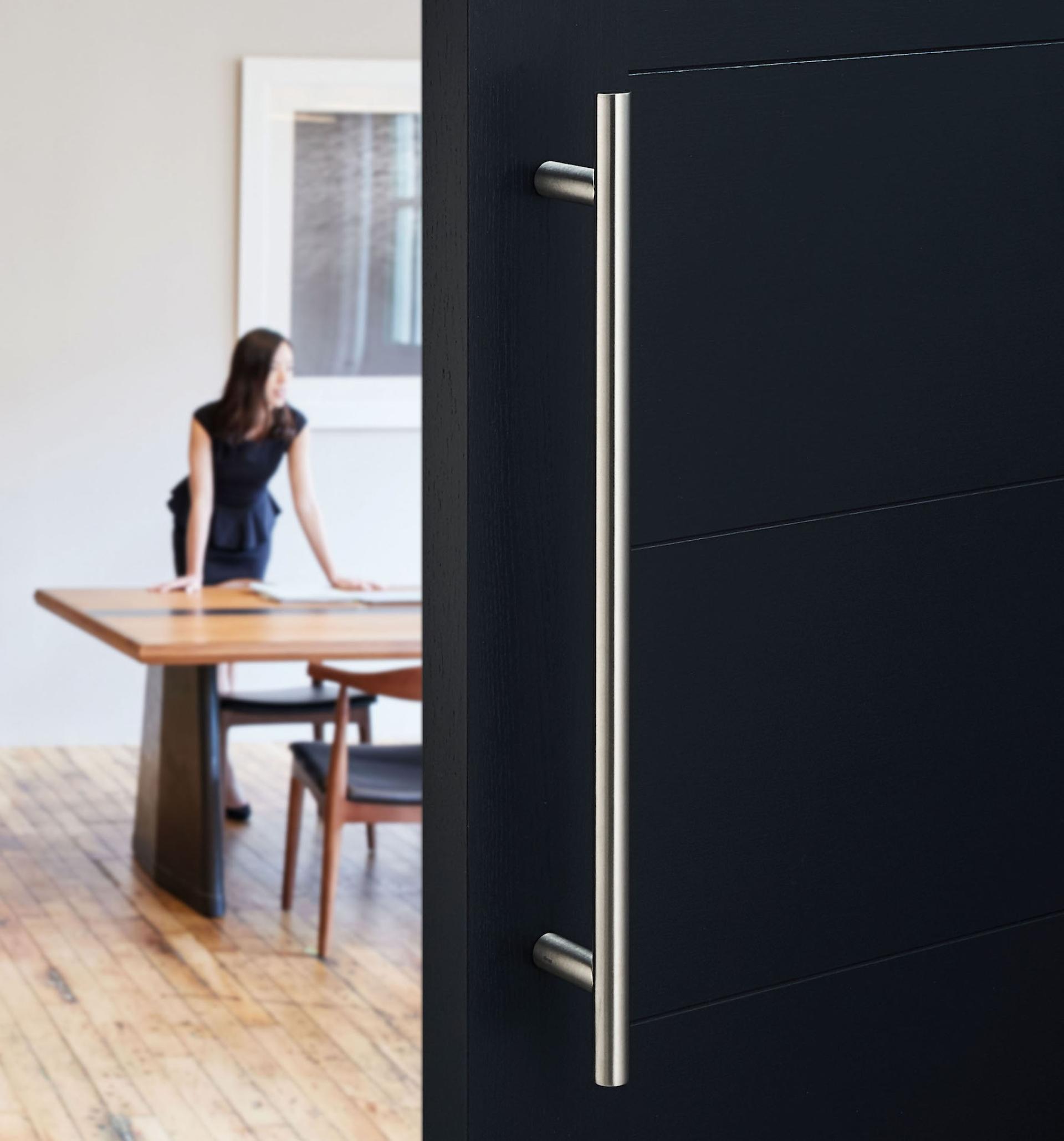 Antimicrobial copper alloy door handle featured in modern interior setting, showcasing Allgood's Contego collection.