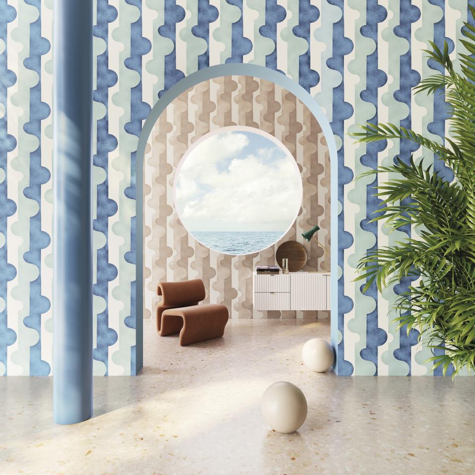 Stylish interior featuring Omexo wallcoverings in soothing colors, with a circular window showcasing scenic views and modern decor.