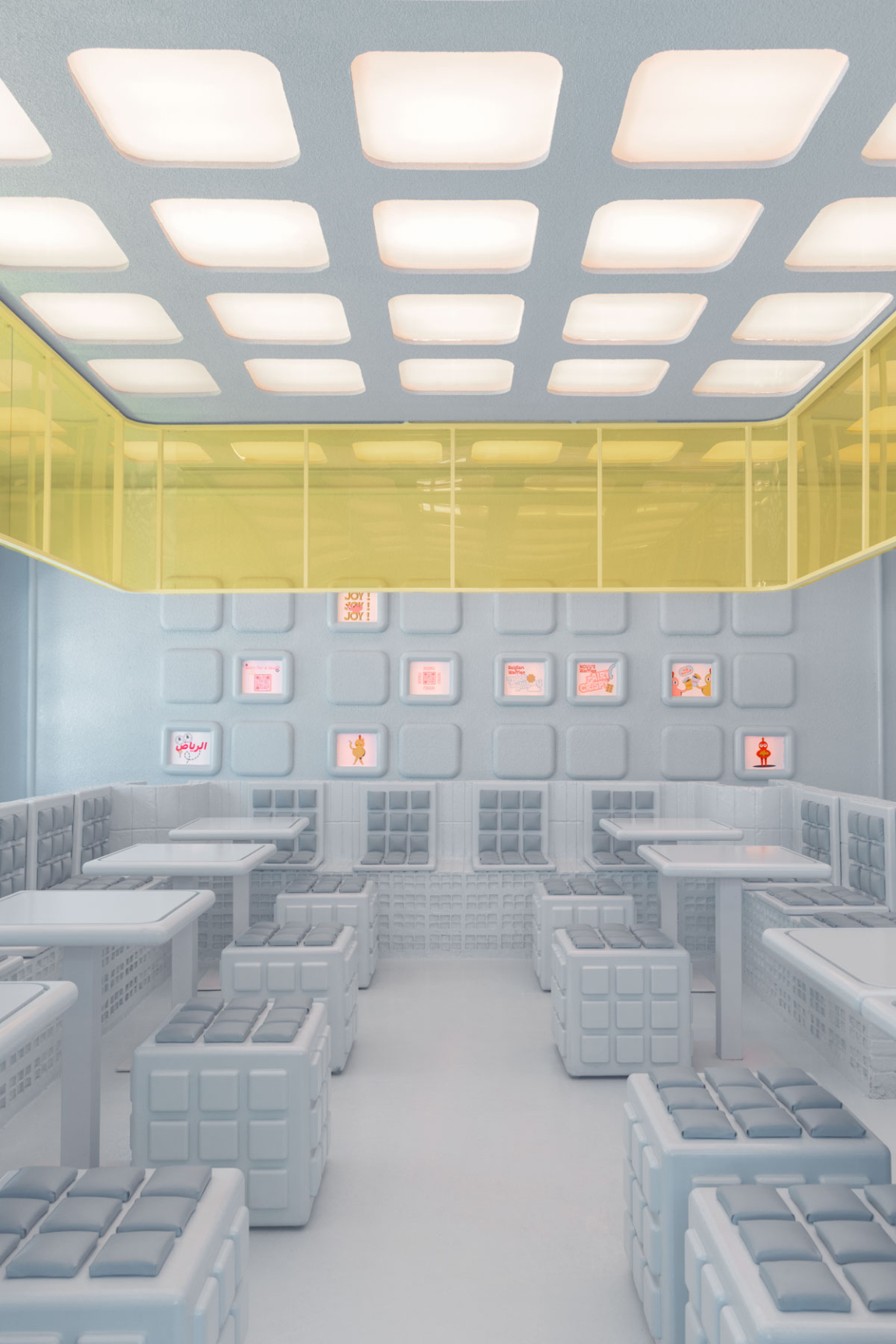 Futuristic dining space design at Novu Waffle featuring modular furniture and illuminated decor by Masquespacio.