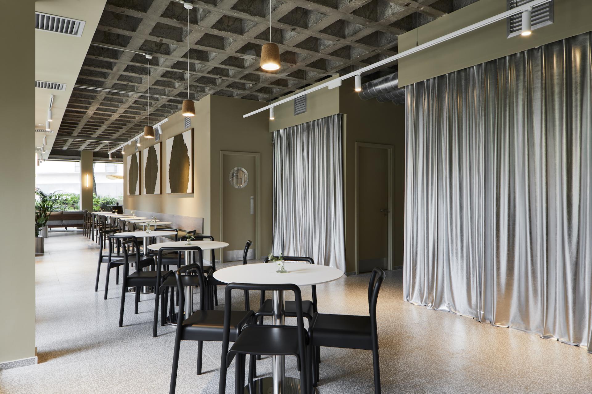 Modern interior of Pollen Bakery featuring elegant tables, stylish chairs, and soft lighting, reflecting quality and heritage design.