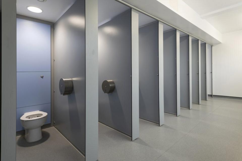 Modern boys' washroom with cubicles and amenities designed for inclusivity at Stretford Grammar School.