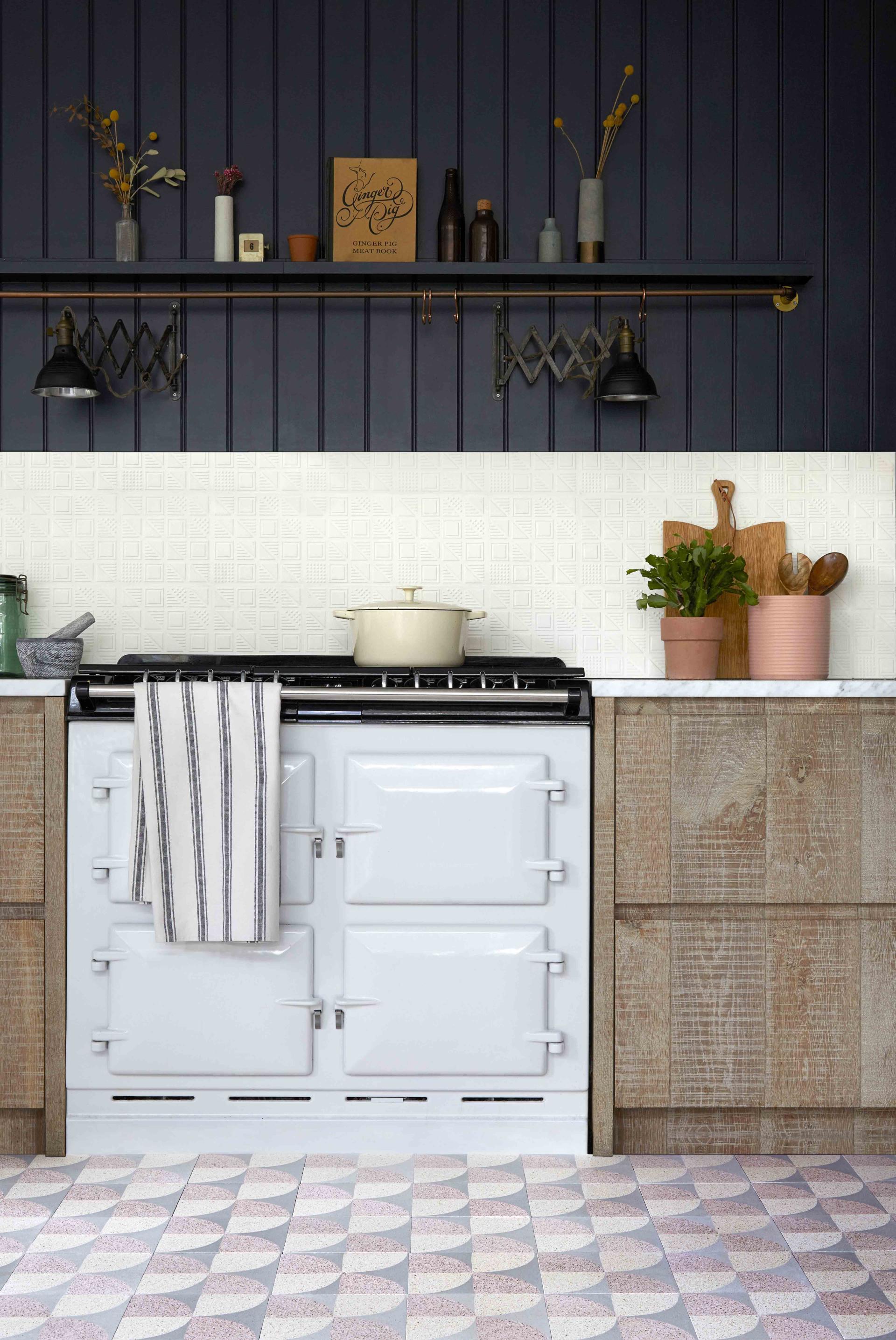 Stylish kitchen featuring Bermondsey patterned tiles by Lindsey Lang, a vintage stove, and rustic wooden cabinetry.