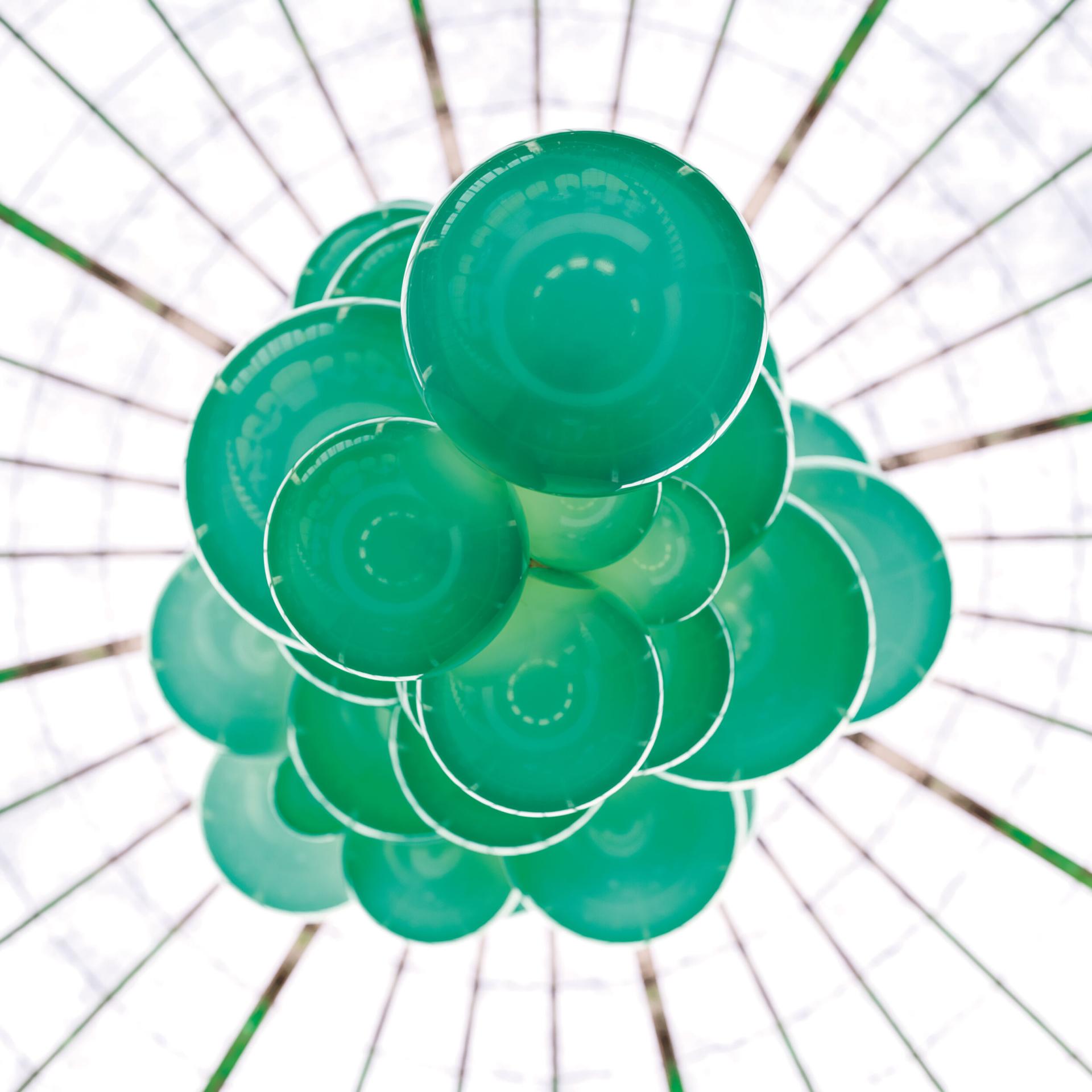 Colorful Kuulas chandelier by Cameron Design House features sculptural glass elements, showcasing innovative lighting design.