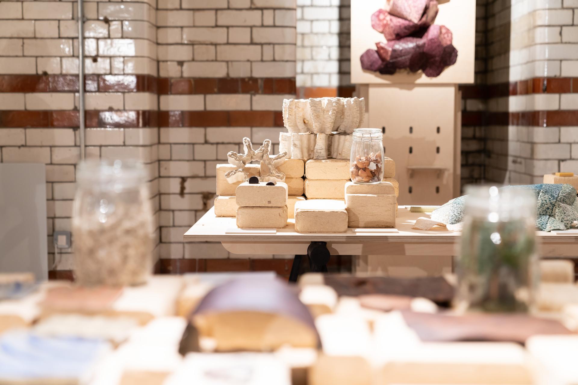 Display of various sustainable materials and objects at Material Source Studio in Glasgow, showcasing innovative design concepts.