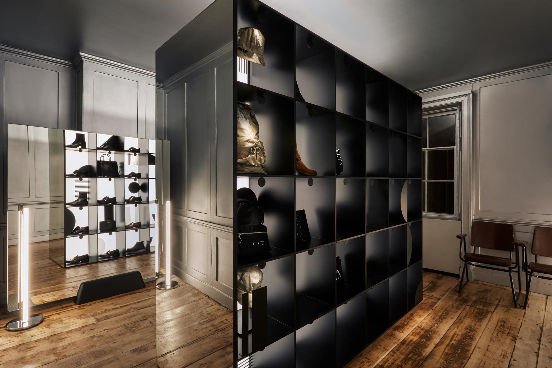 Elegant retail display featuring a modular shelving unit and mirror, designed by Nulty for Browns in London.