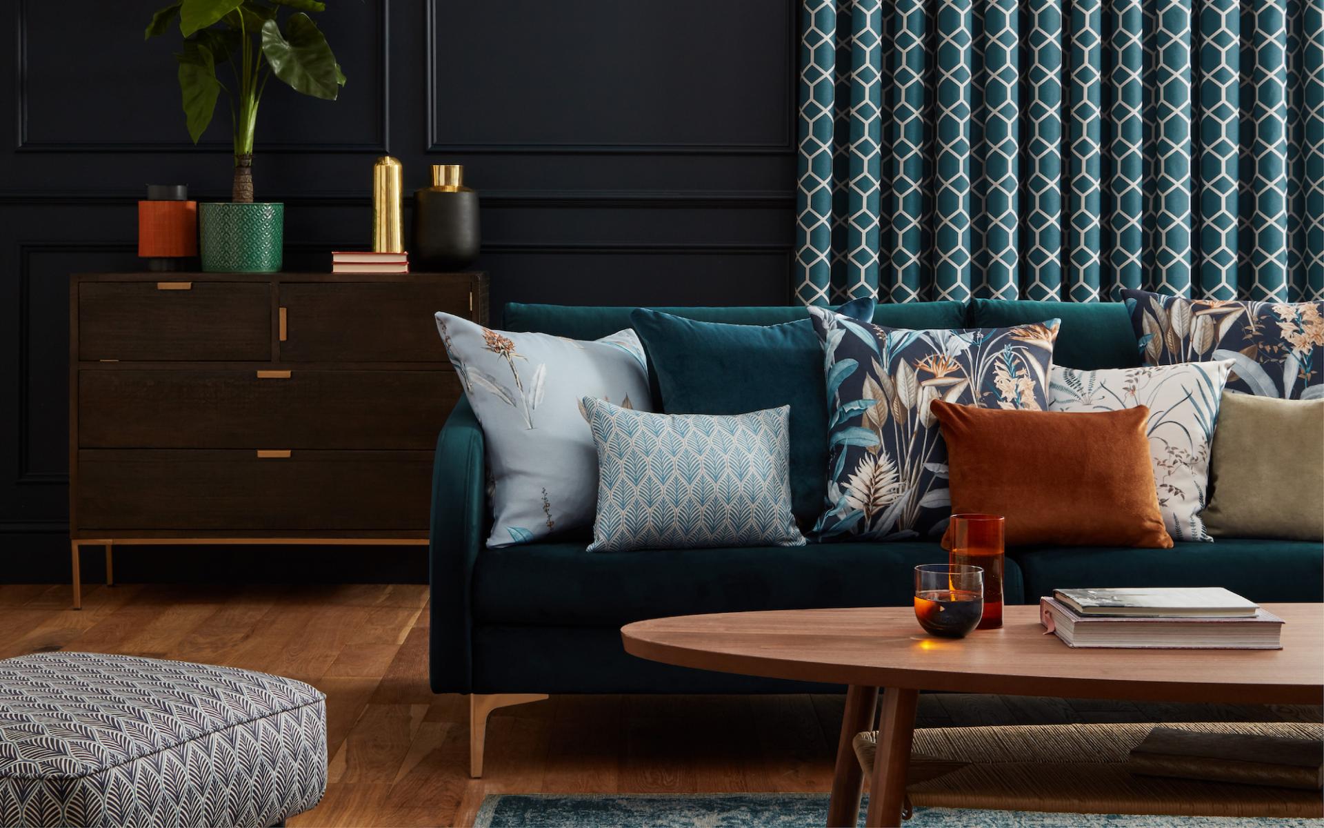 Stylish living room corner featuring a plush teal sofa with decorative pillows and an elegant wooden coffee table.
