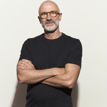 Jasper Sanders, founder of JS+P, confidently poses with crossed arms, emphasizing his commitment to sustainable design practices.