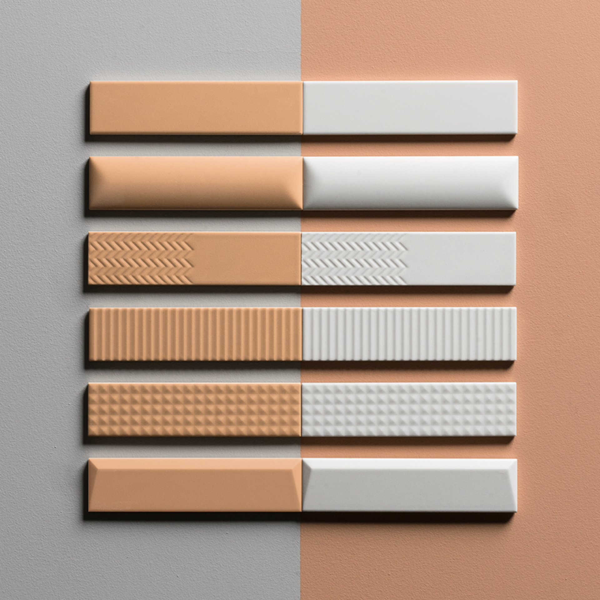Textured ceramic samples in peach and white hues displayed at the Surface Design Show, showcasing innovative surface design options.