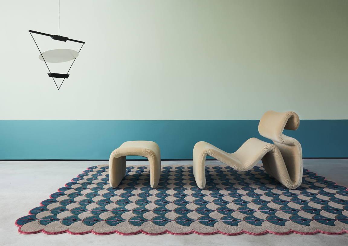 Whimsical modern furniture against a pastel wall, showcasing unique design influenced by Indonesian heritage and creativity.