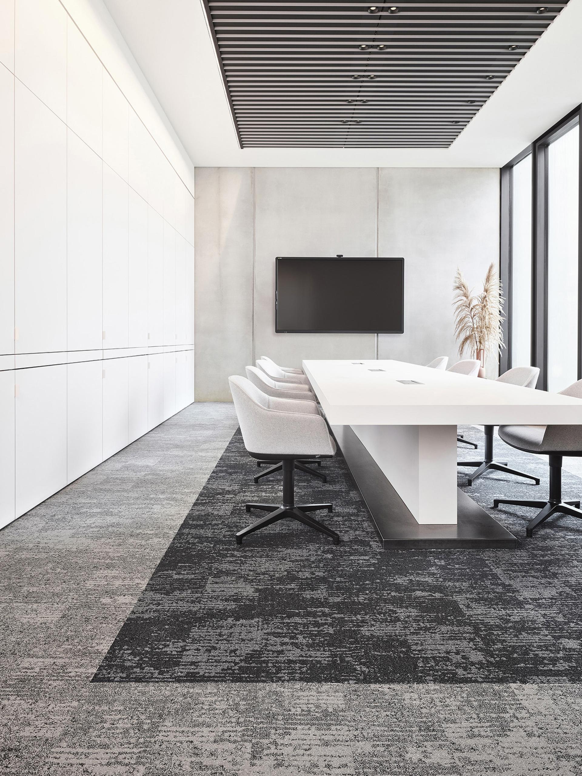 Modern conference room featuring minimalist design, wabi-sabi elements, and a blend of light and dark textures.