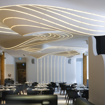 Elegant restaurant interior of VELA featuring ambient lighting designed to resemble a constellation of stars.