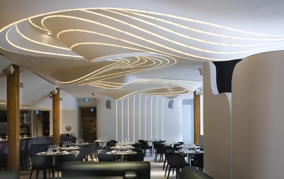 Elegant restaurant interior of VELA featuring ambient lighting designed to resemble a constellation of stars.