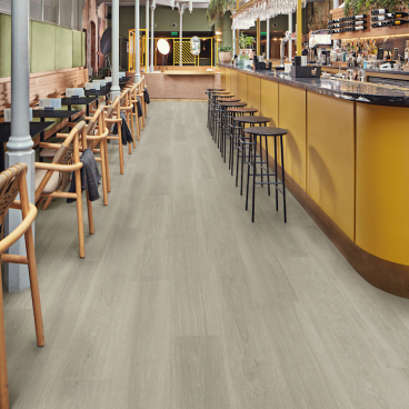 Interior view of a bar featuring Karndean's natural oak flooring, showcasing a modern design and vibrant atmosphere.