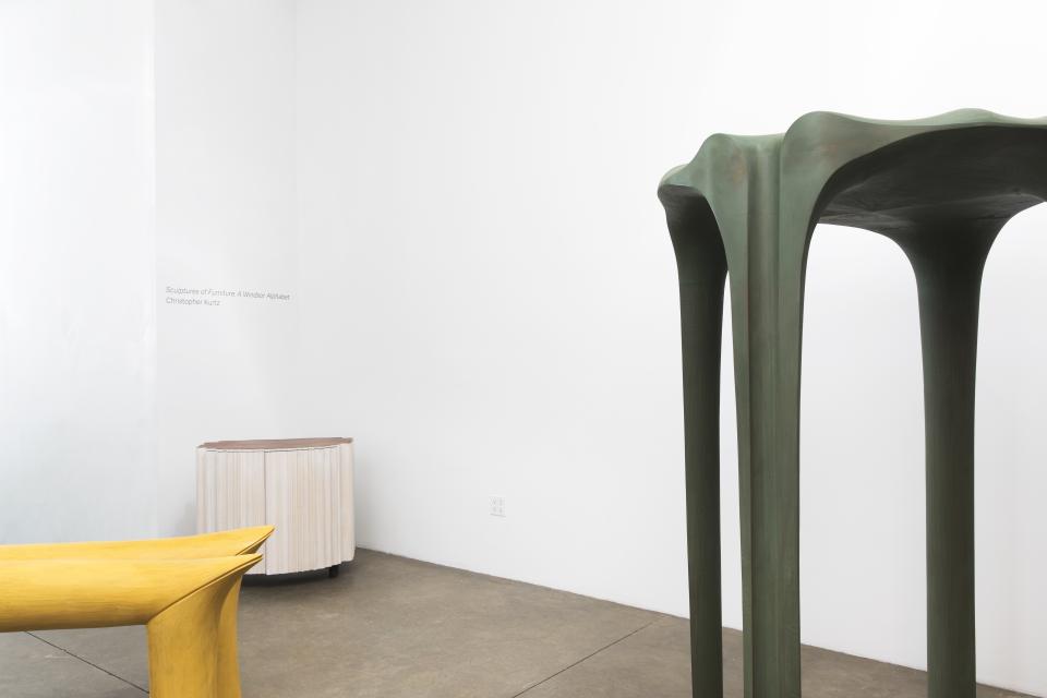 Innovative furniture sculptures by Christopher Kurtz, showcasing a reimagined Birdcage Windsor chair in a gallery setting.