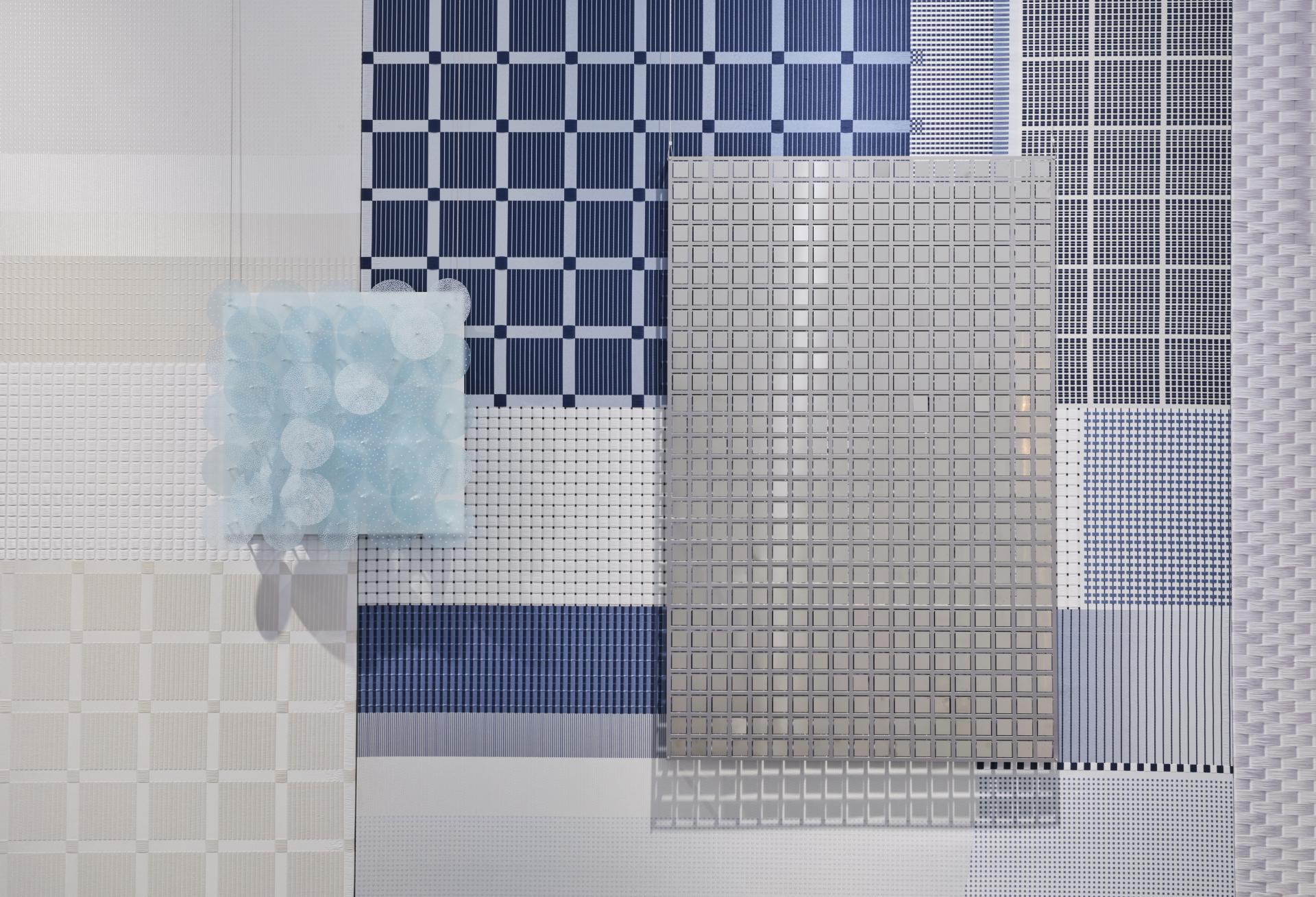 Abstract wall design featuring textured patterns in blue and white, showcasing innovative materials for sensory well-being experiences.