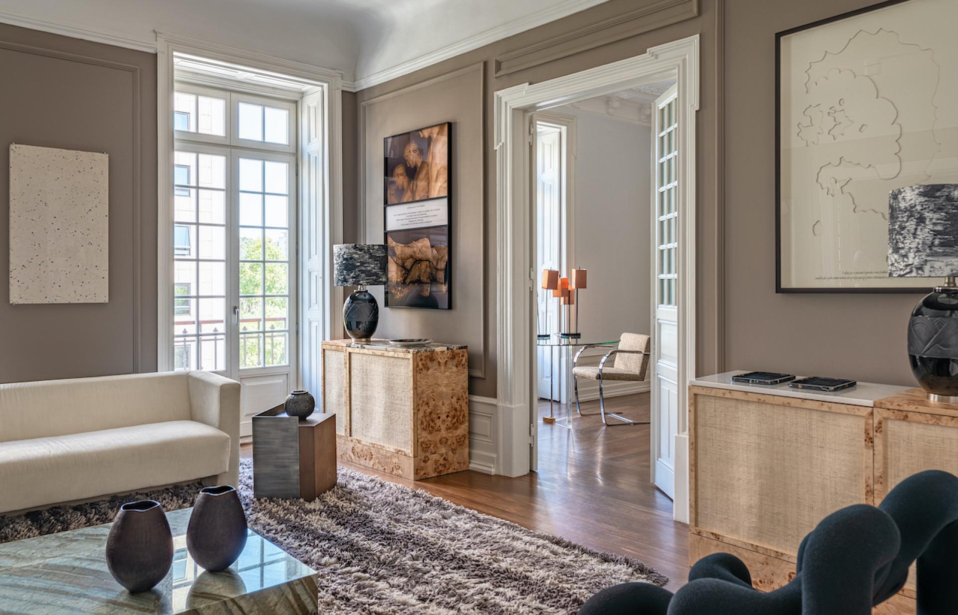 Elegant living room featuring modern furniture pieces by Cristina Jorge de Carvalho, artful decor, and natural light.