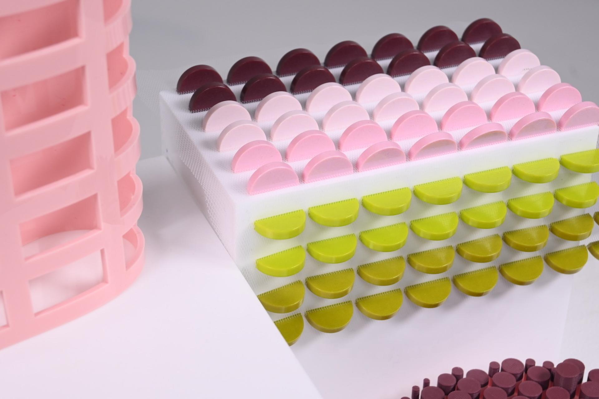 Colorful geometric models exhibited at the Manchester School of Art showcase innovative design techniques from recent graduates.