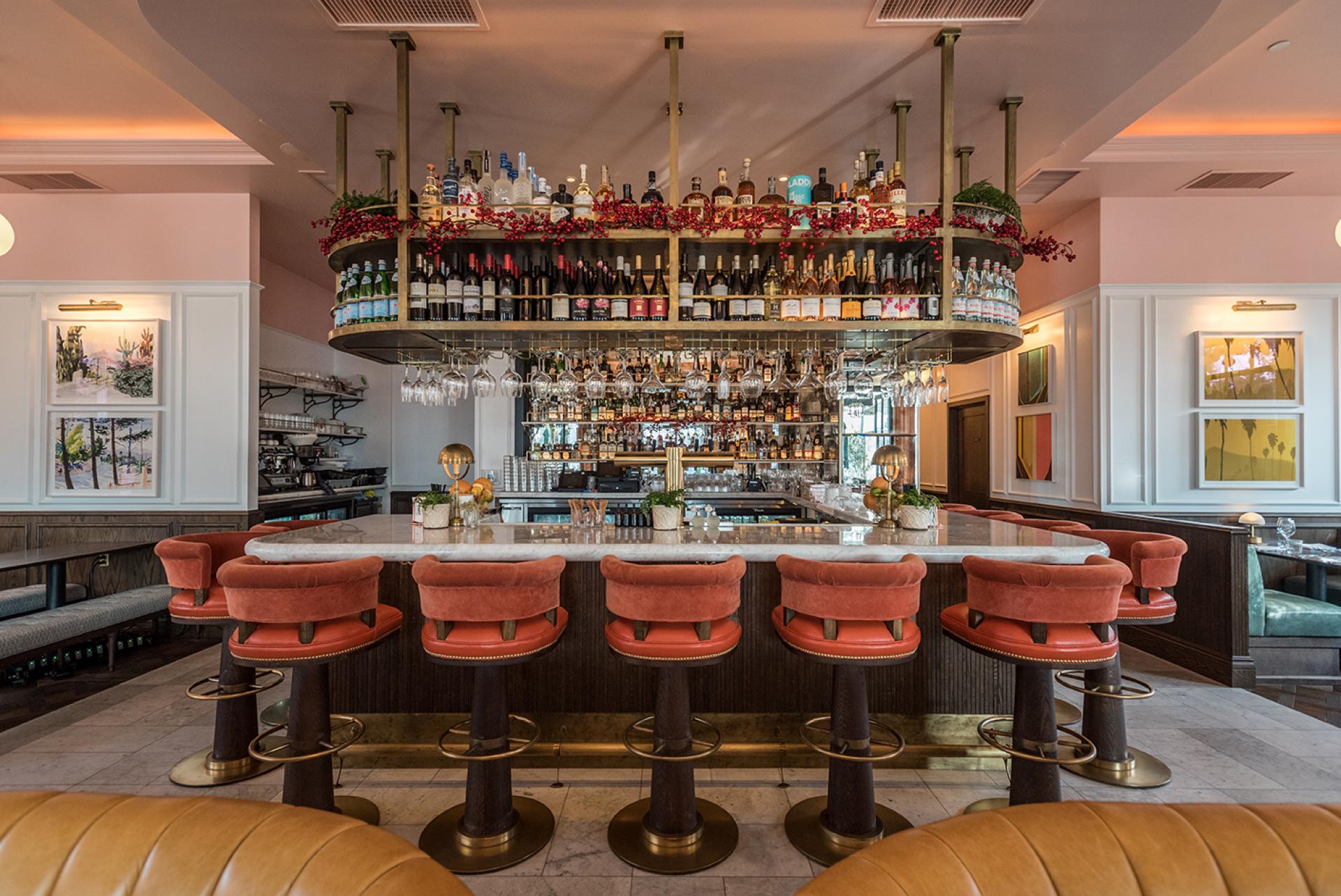 Elegant bar at The Draycott featuring plush seating, a stylish drink display, and California-inspired decor.