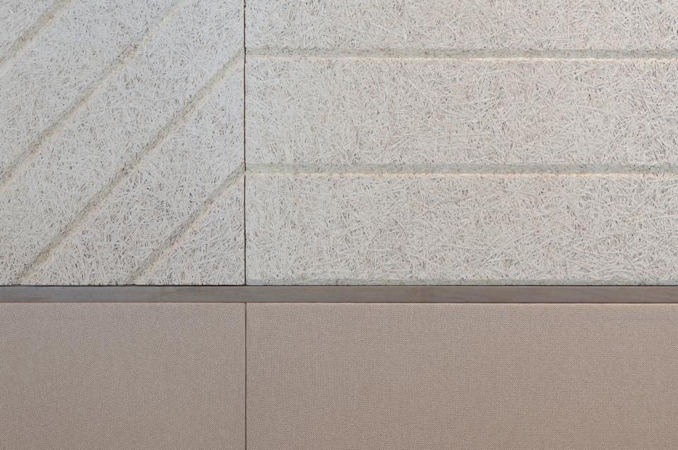 Textured wall featuring a modern design of natural materials, showcasing innovative architecture by Bean Buro for Warner Music Hong Kong.