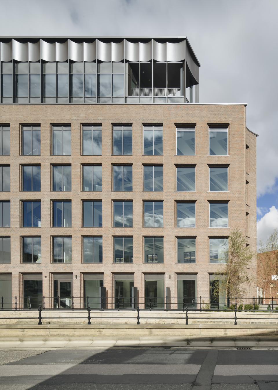 Modern building facade at Globe Point, Leeds, showcasing industrial design elements and large glass windows.