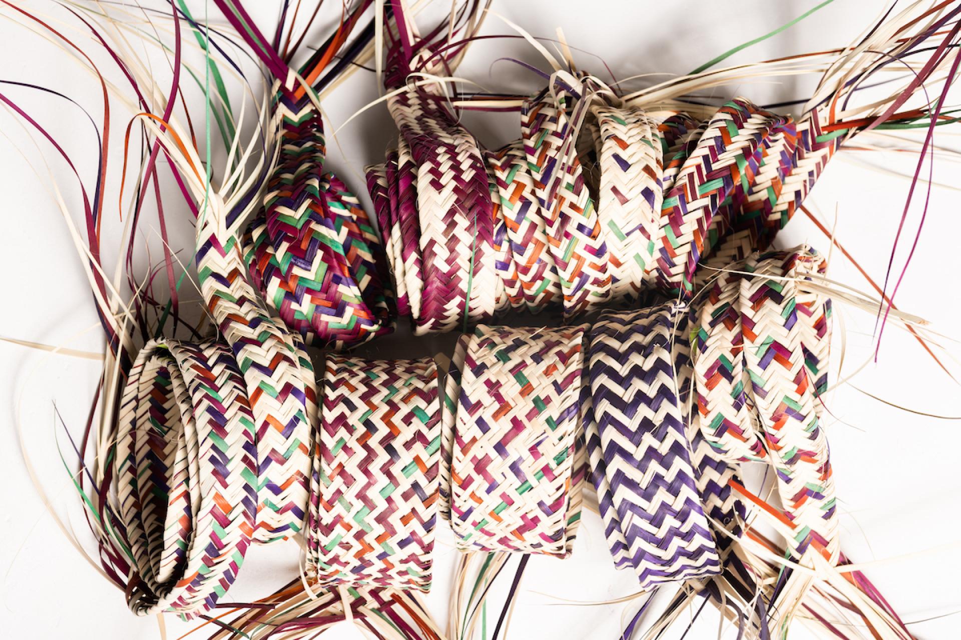 Colorful woven baskets made of natural fibers, showcasing traditional craftsmanship at Irthi Contemporary Crafts Council's London Design Fair debut.