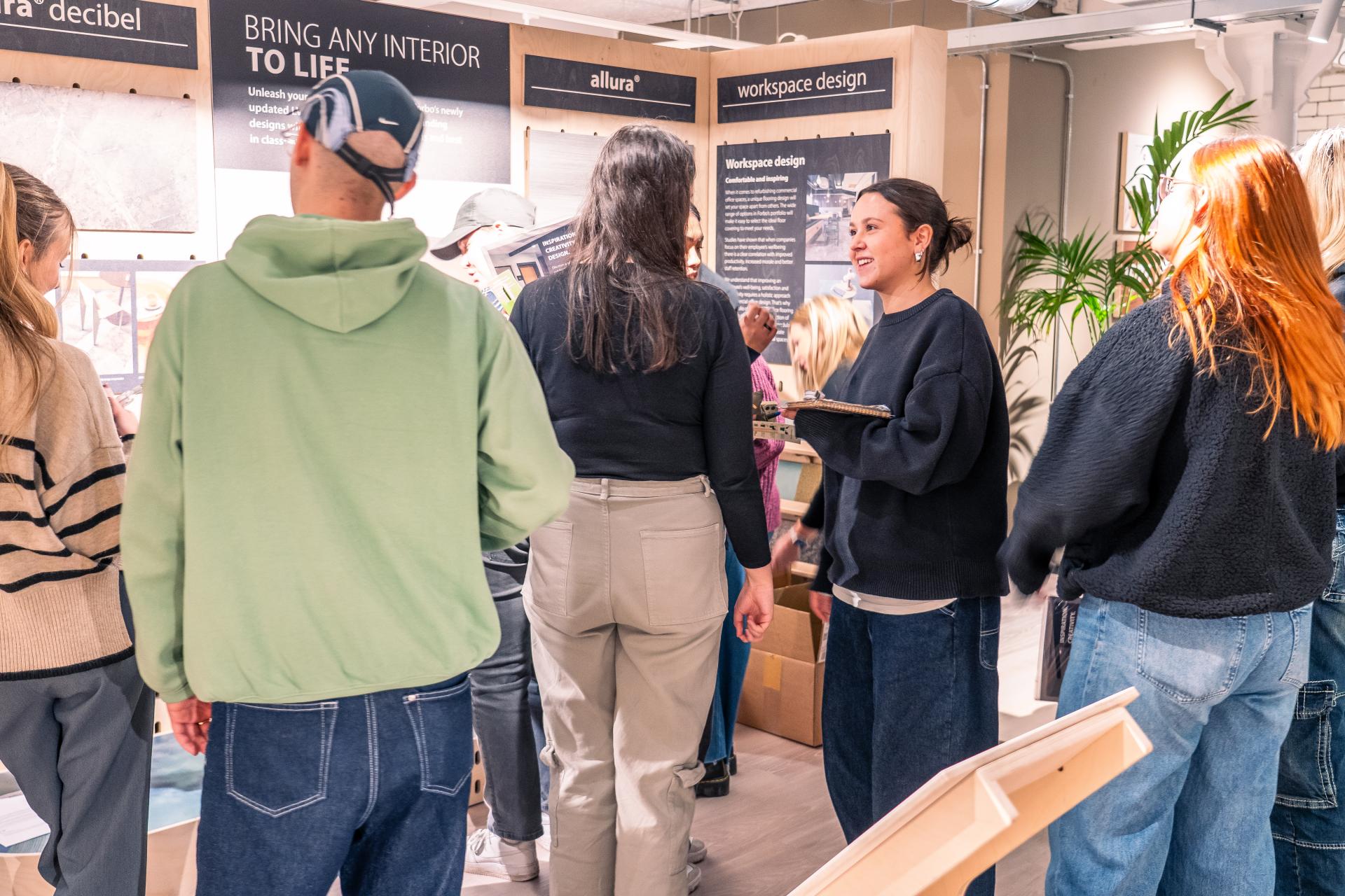 Students engaging in discussions about innovative workspace design during MMU's Green Week event.