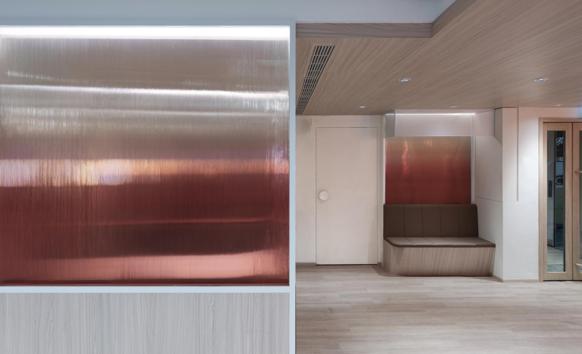 Modern interior design of Unicorn Stores HQ featuring sleek copper wall accent and stylish seating area.