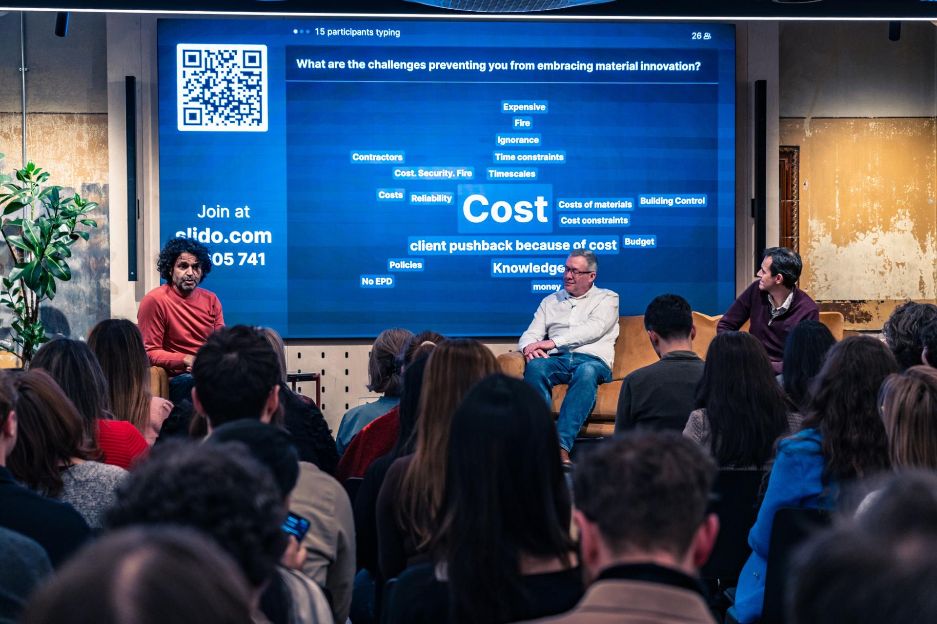 Panel discussion on material innovation challenges, focusing on cost and budget concerns for achieving Net Zero goals.