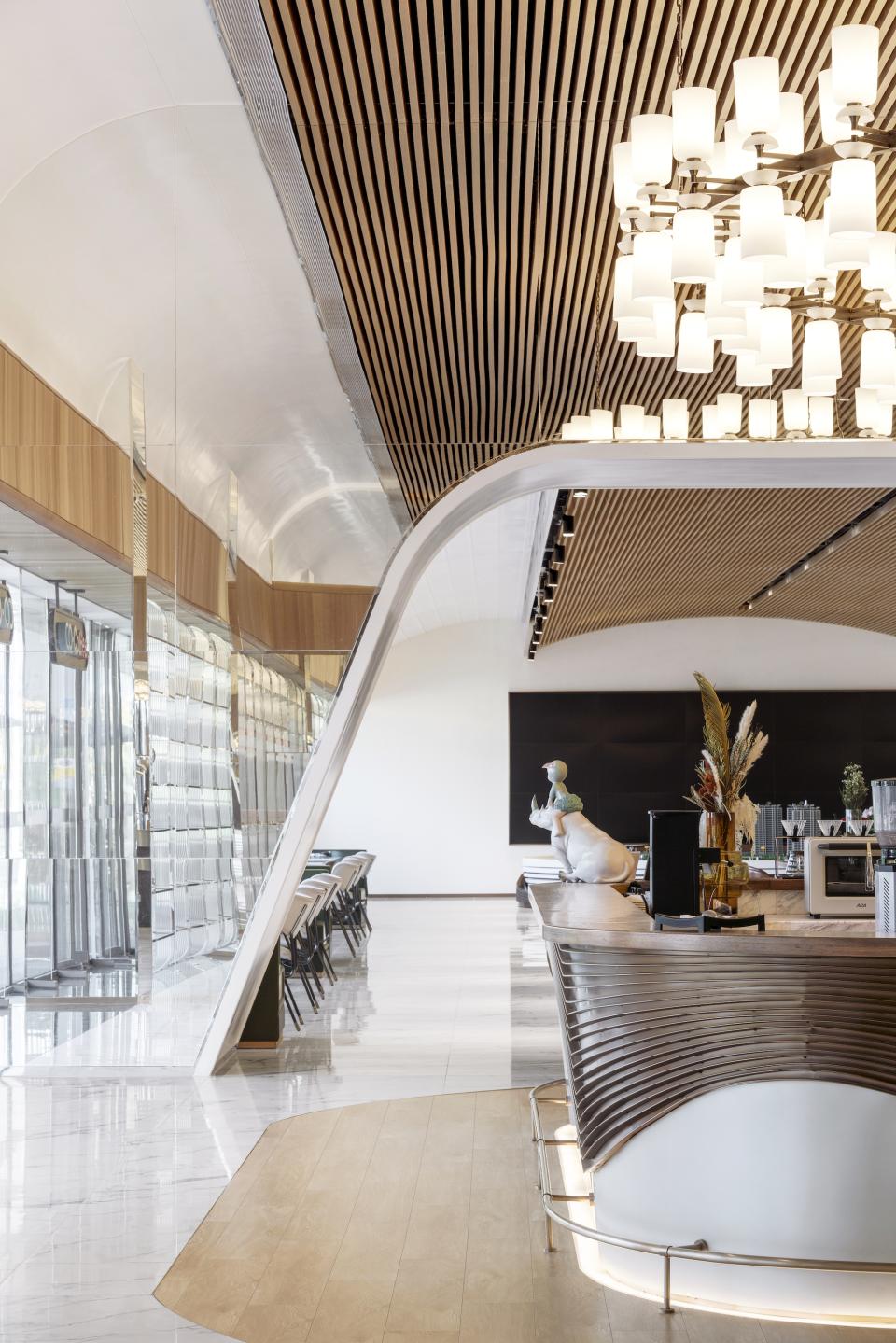 Modern coffee shop interior showcasing elegant design with wood accents, high-end lighting, and a welcoming atmosphere.