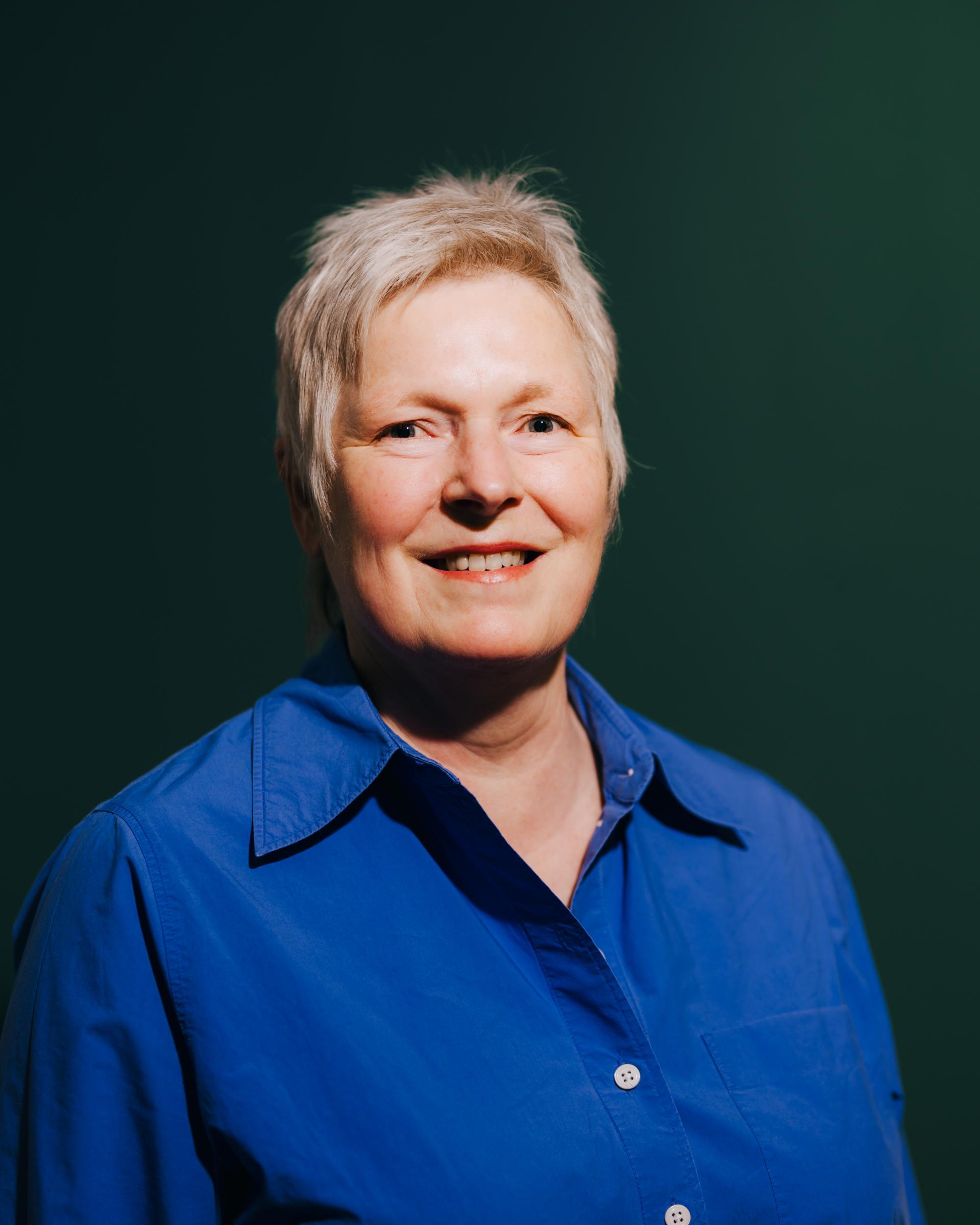 Smiling woman in a blue shirt, representing a discussion on neurodiversity and flexibility at Material Source Studio Glasgow.
