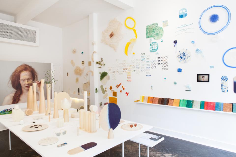 Biodegradable plastic materials, including textured samples and potential designs, displayed in a modern studio setting.