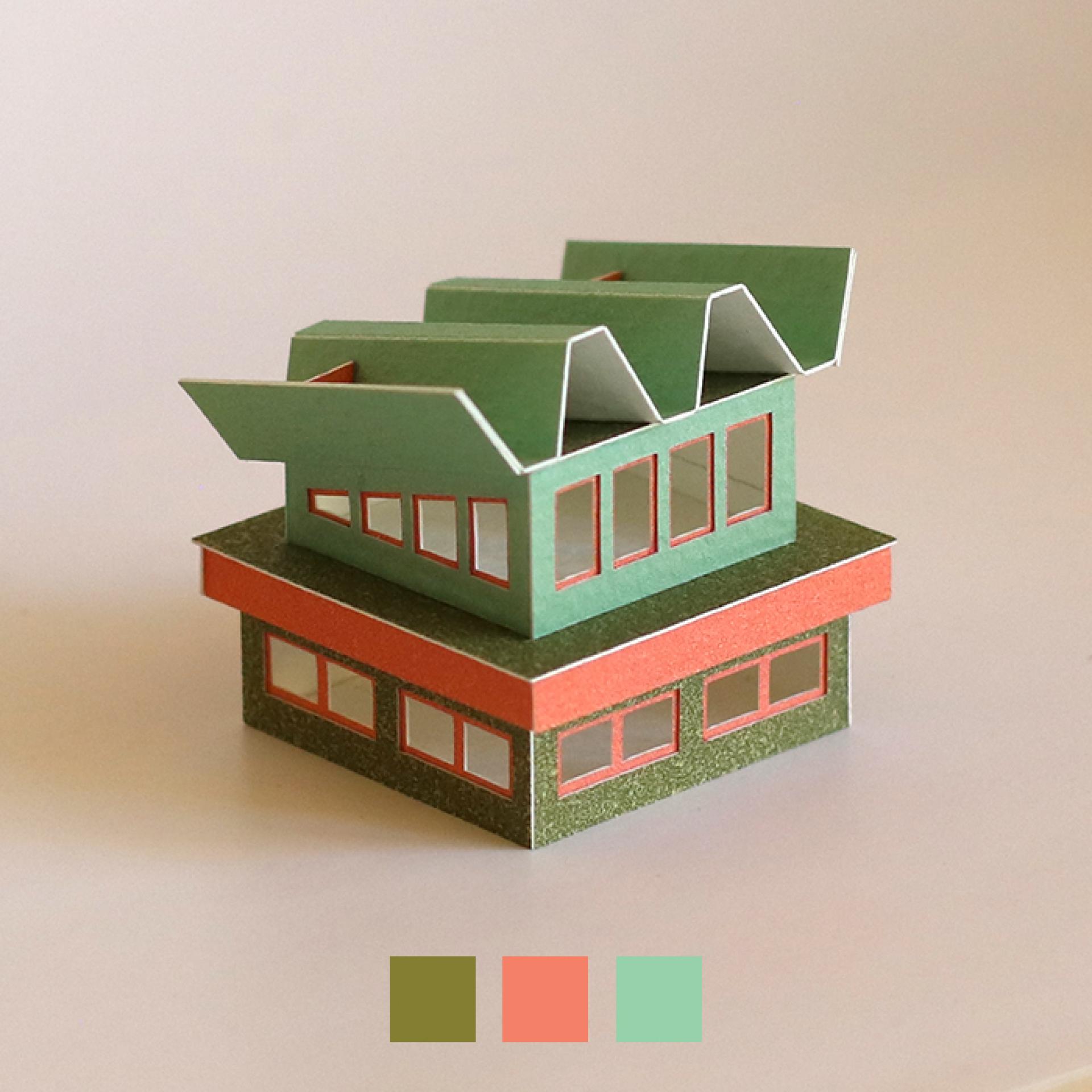 Colorful miniature paper building model showcasing modern architectural design, featured in Charles Young's creative work.