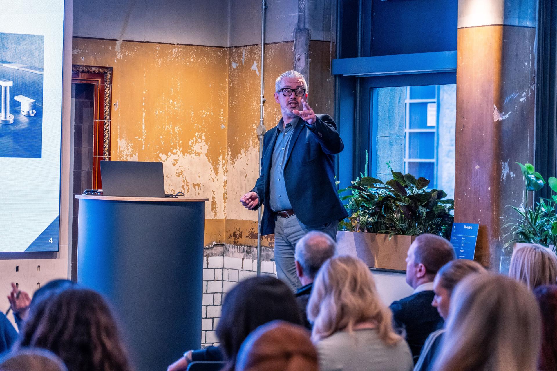 Speaker discussing sustainable design principles at MMU's Green Week event, highlighting the future of interior design.