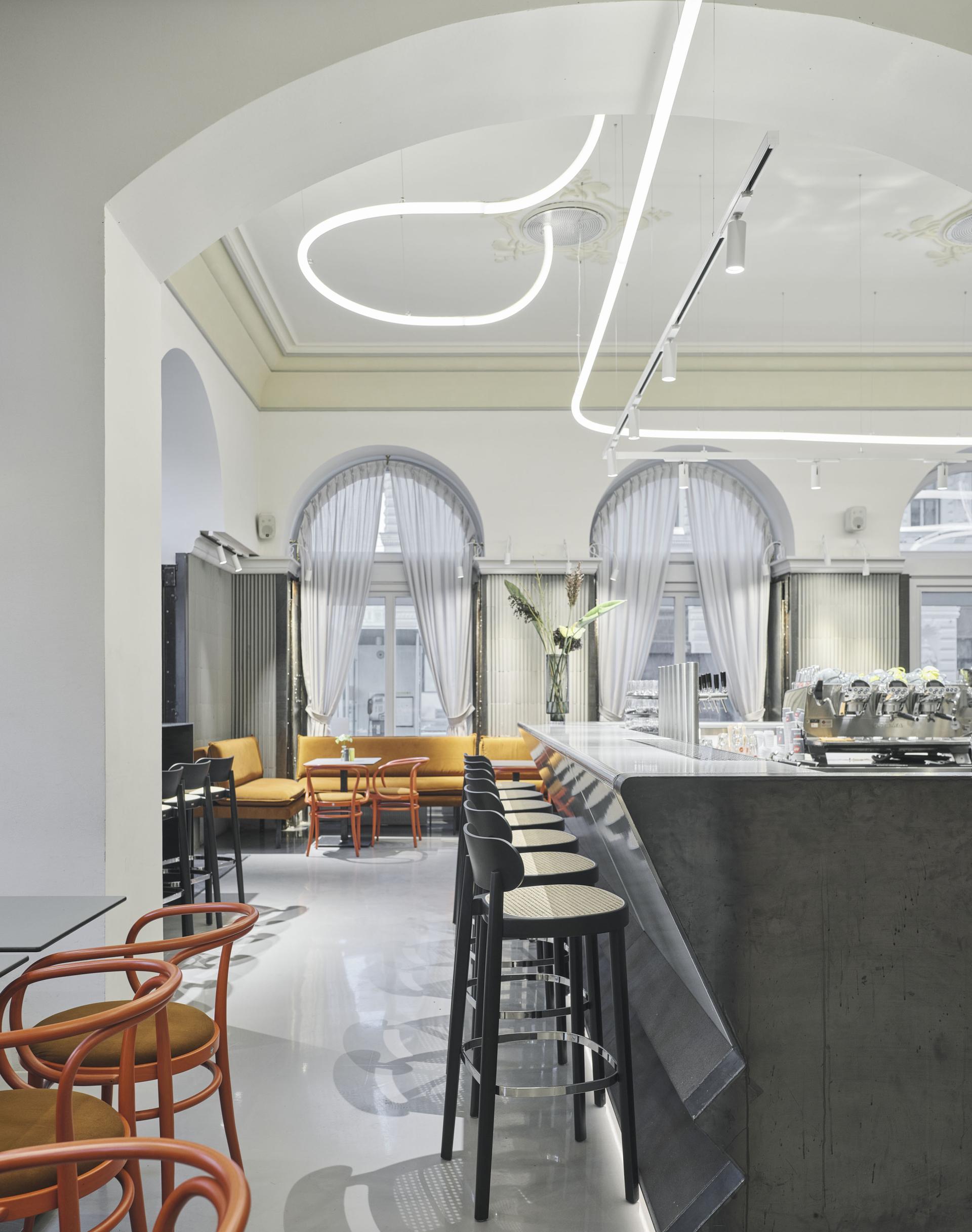 Modern interior of Café Bellaria in Vienna, featuring sleek furniture and a stylish bar, blending tradition with contemporary design.