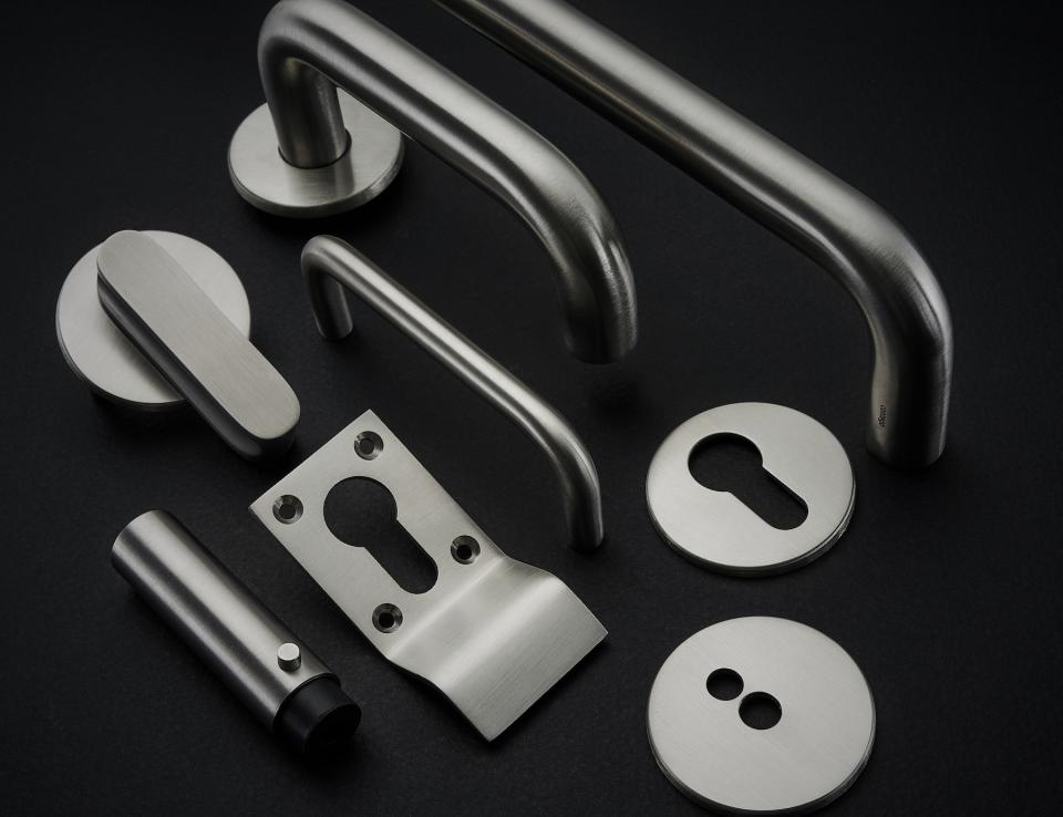 Antimicrobial copper alloy architectural hardware pieces from Allgood's Contego collection displayed on a dark background.