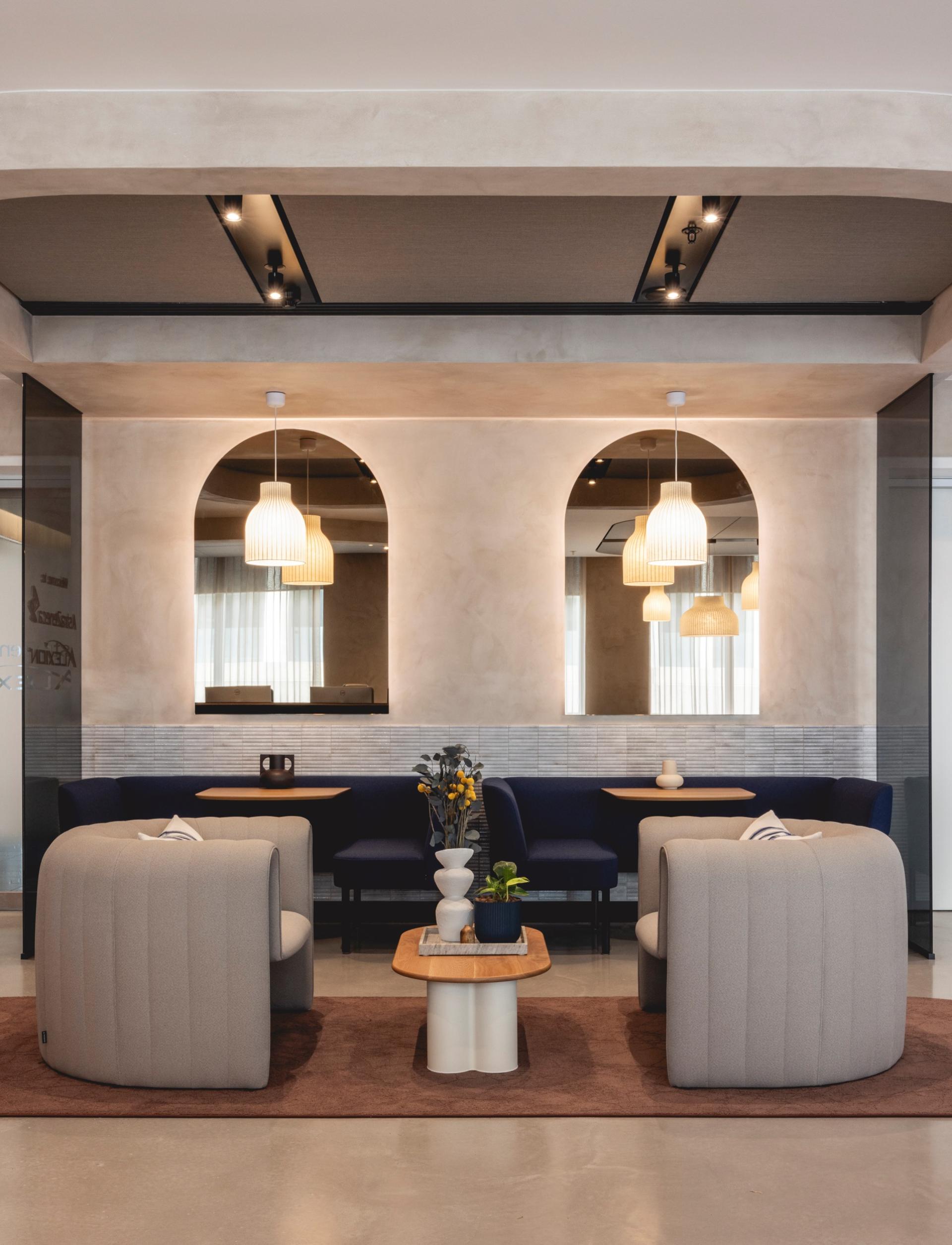 Elegant Art Deco-inspired workspace featuring curved furniture, ambient lighting, and a soothing color palette by Ekho Studio.