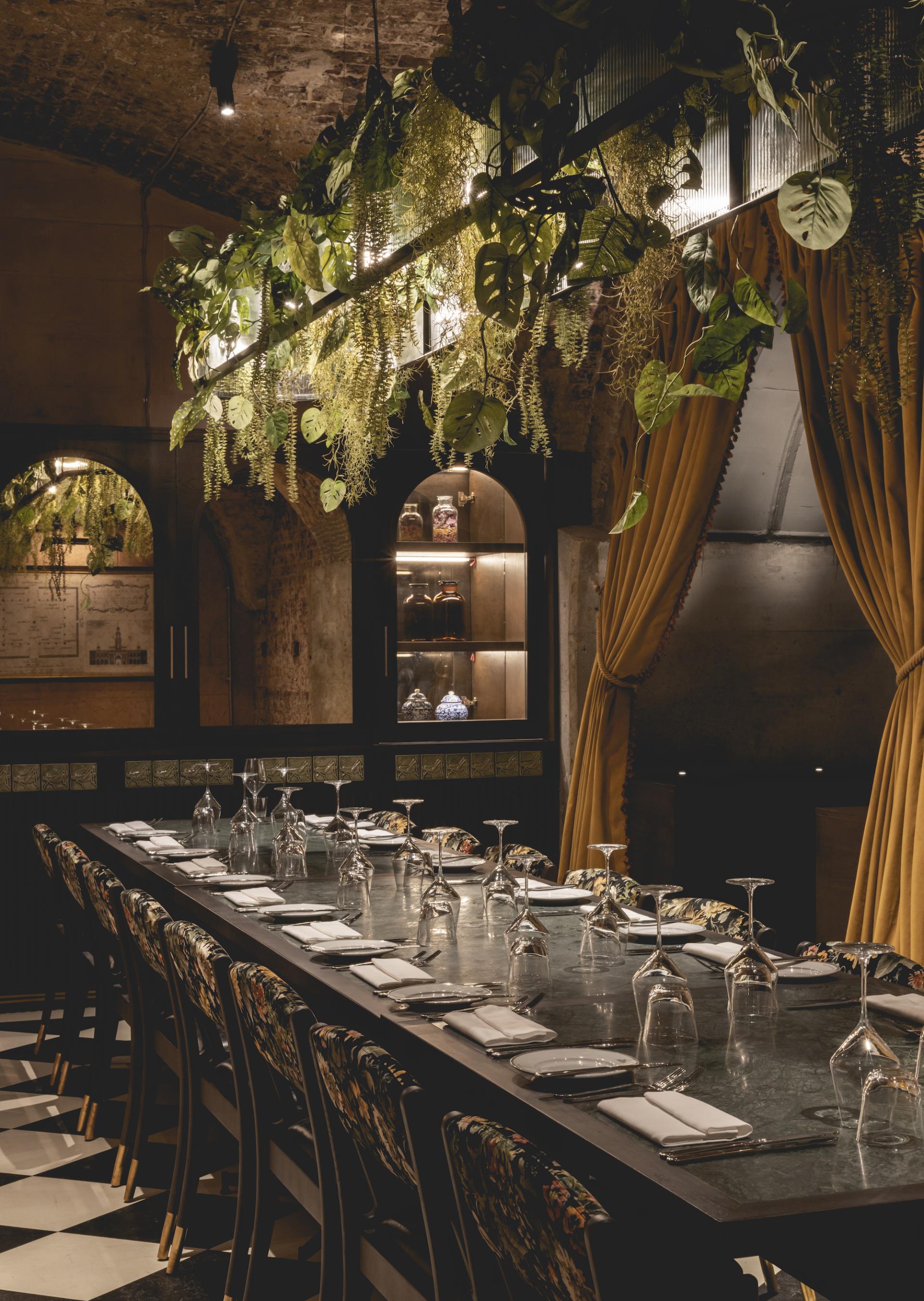 Elegant dining setup featuring decorative plants and stylish seating in The Libertine, a new venue in London's Royal Exchange.