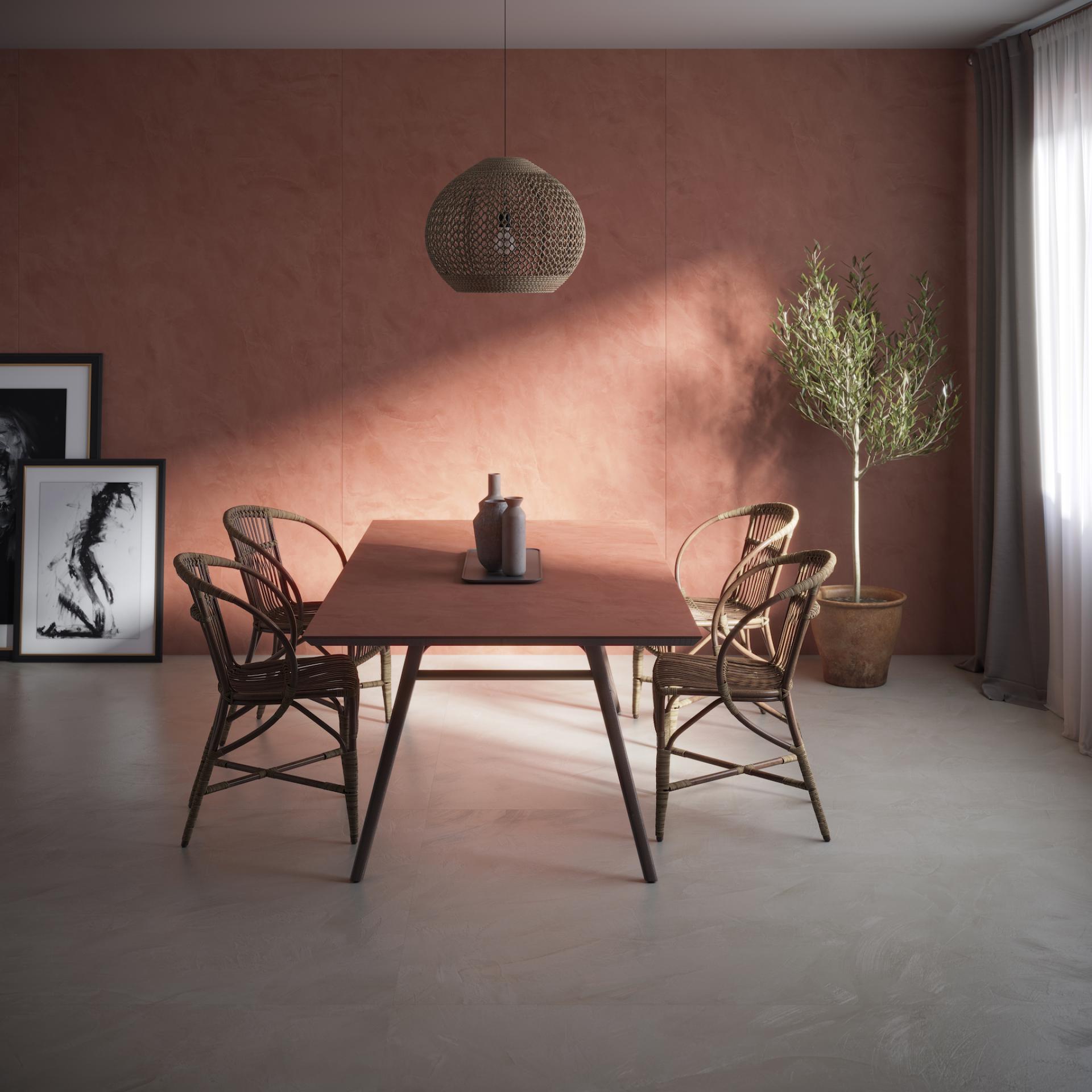 Stylish dining area featuring Dekton® surfaces, natural lighting, and modern decor elements in warm tones.