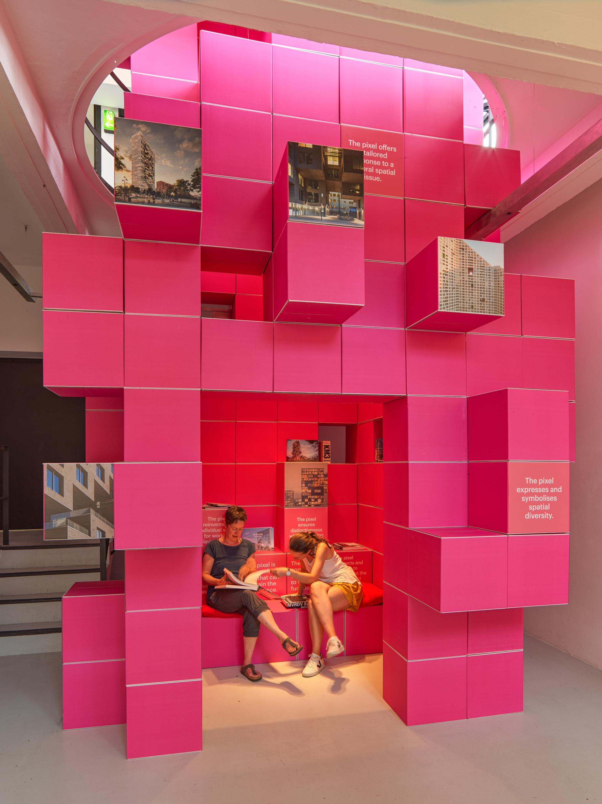 Interactive installation by MVRDV featuring bright pink modular elements, showcasing architecture concepts at the Architecture Speaks exhibition.