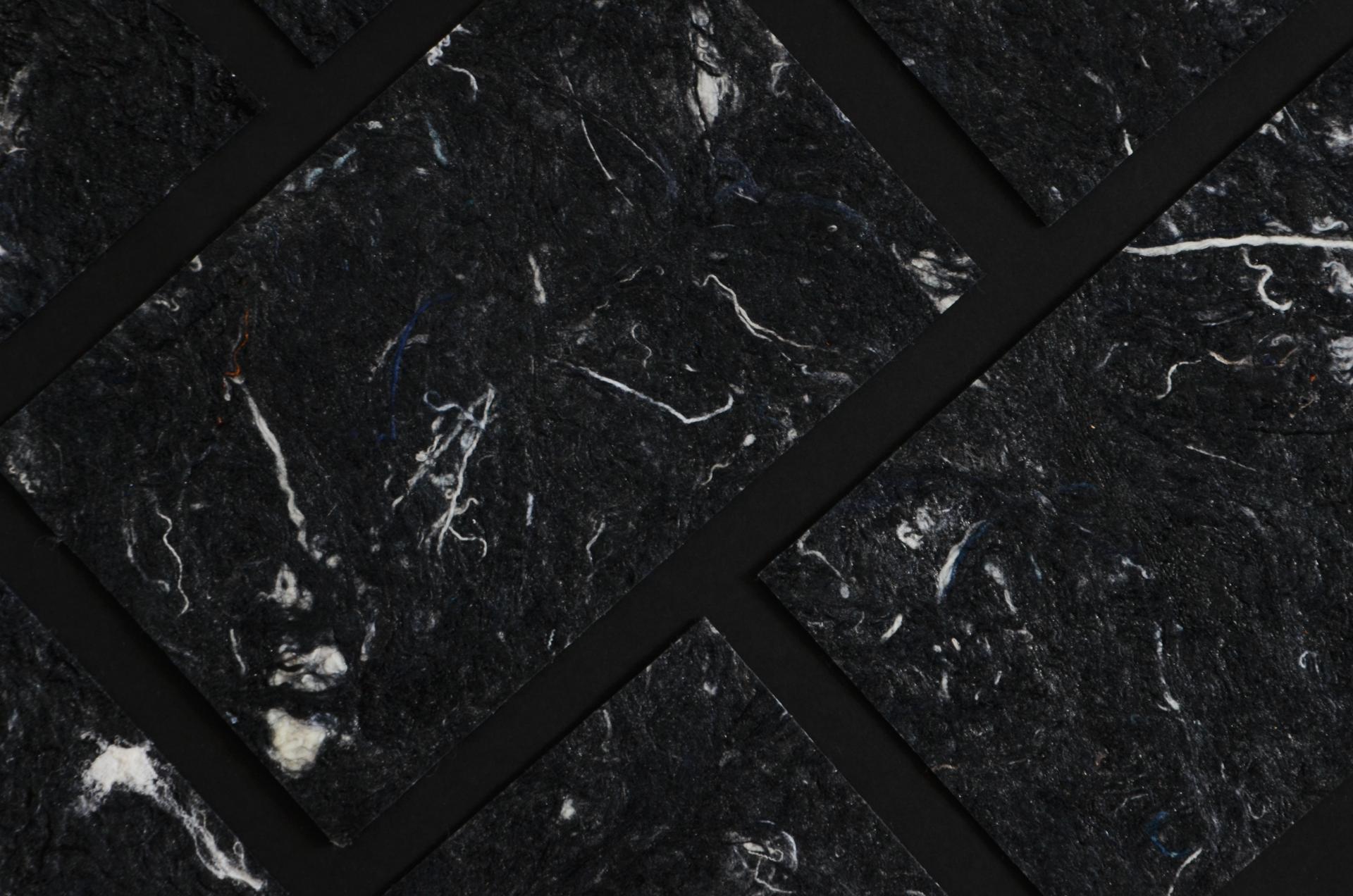 Textured black biomaterial sheets, reflecting sustainable design and innovative use of reimagined waste by Studio Sarmite.