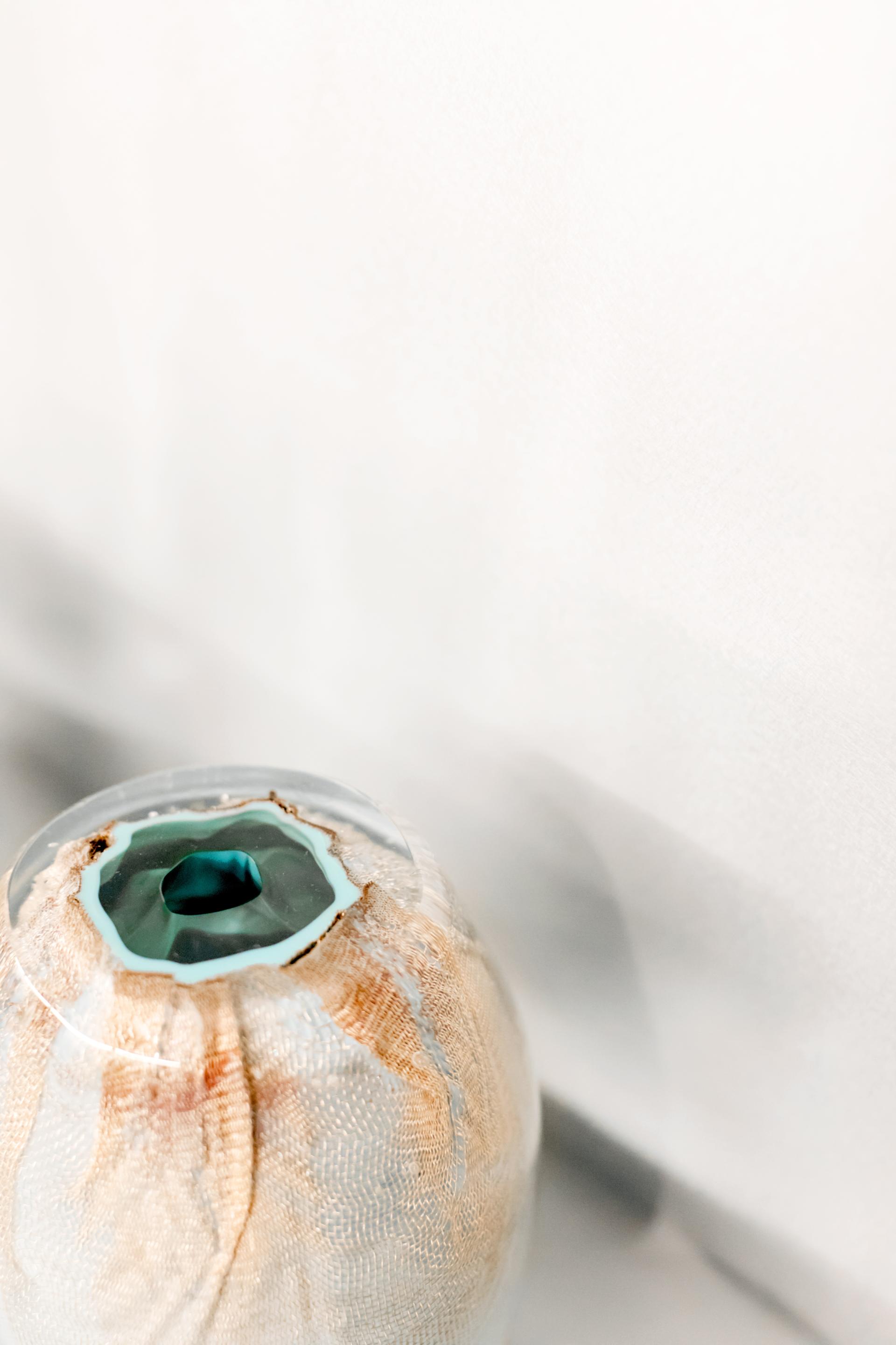 Stylish glass sculpture with textured fabric wrapping, illustrating Bocci's commitment to innovative design and craftsmanship.