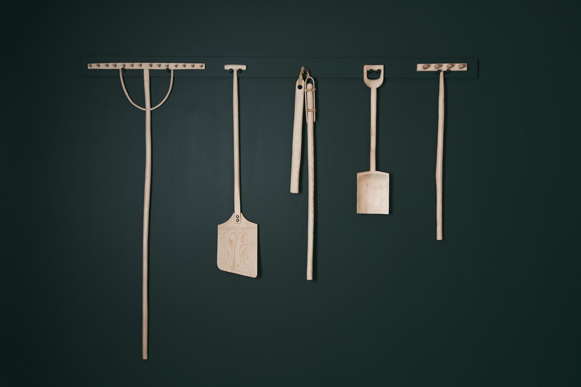 Handcrafted wooden tools displayed on a wall, showcasing the beauty and craft potential of Scotland's native ash tree.