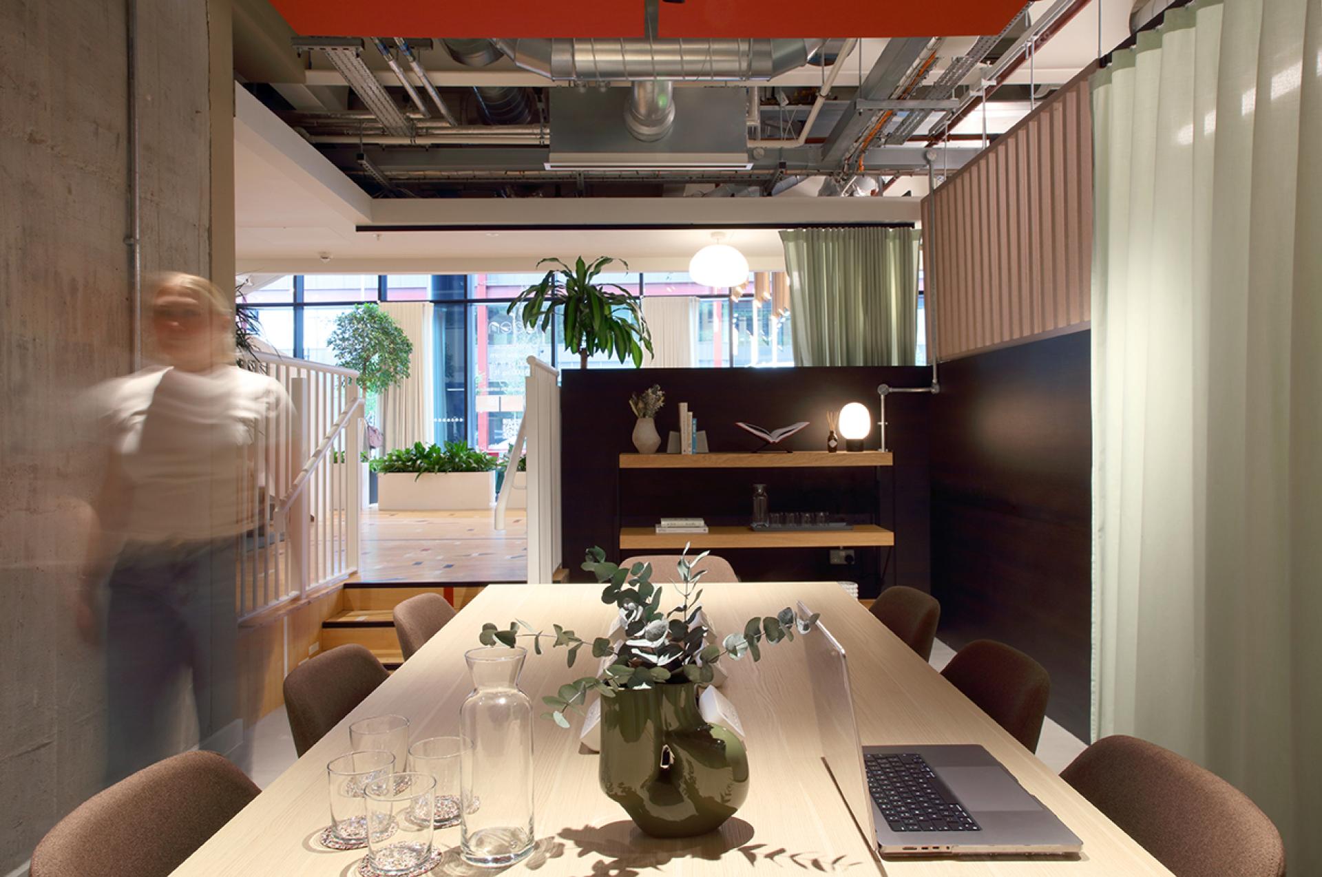 Stylish social hub at Eden, New Bailey featuring modern decor, plants, and collaborative workspace amenities for community engagement.