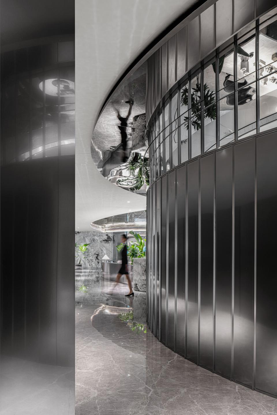 Sleek interior design featuring curved walls and reflective surfaces at the Foshan Vanke Financial Centre project by Karv One.